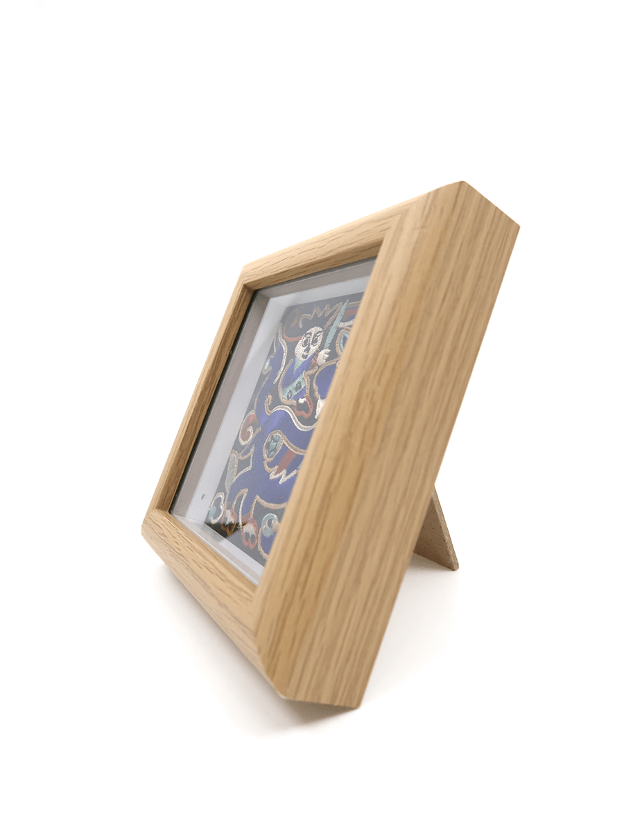 Wood finish photo frame with a stand on a white background