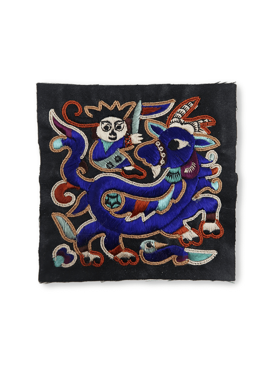 Decorative patch with embroidered design on a black background