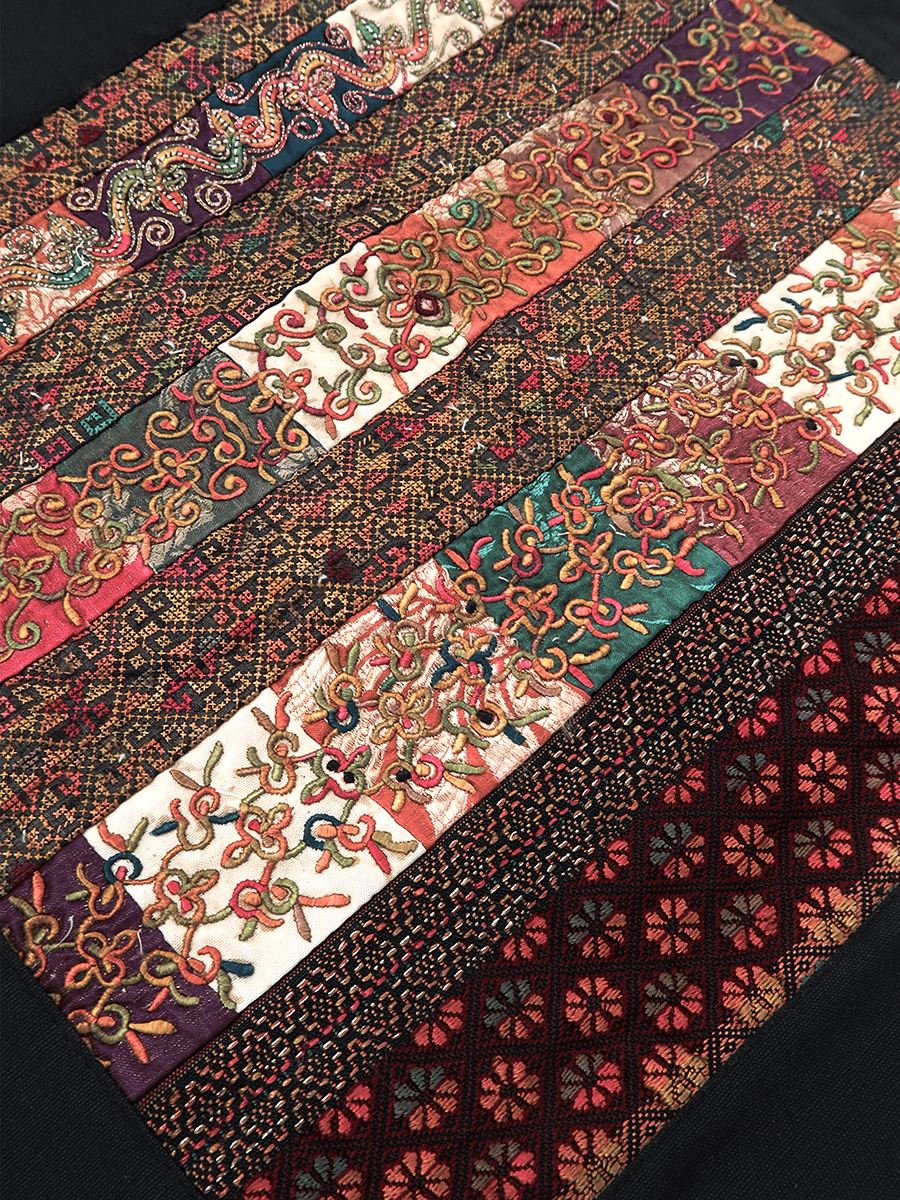Patterned fabric strips arranged in a patchwork design on a dark background